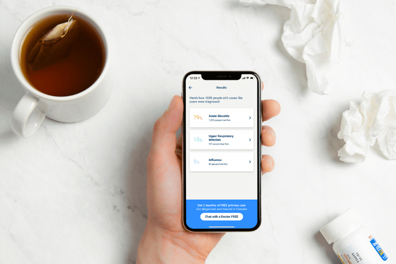 Hand holding phone showing K Health app