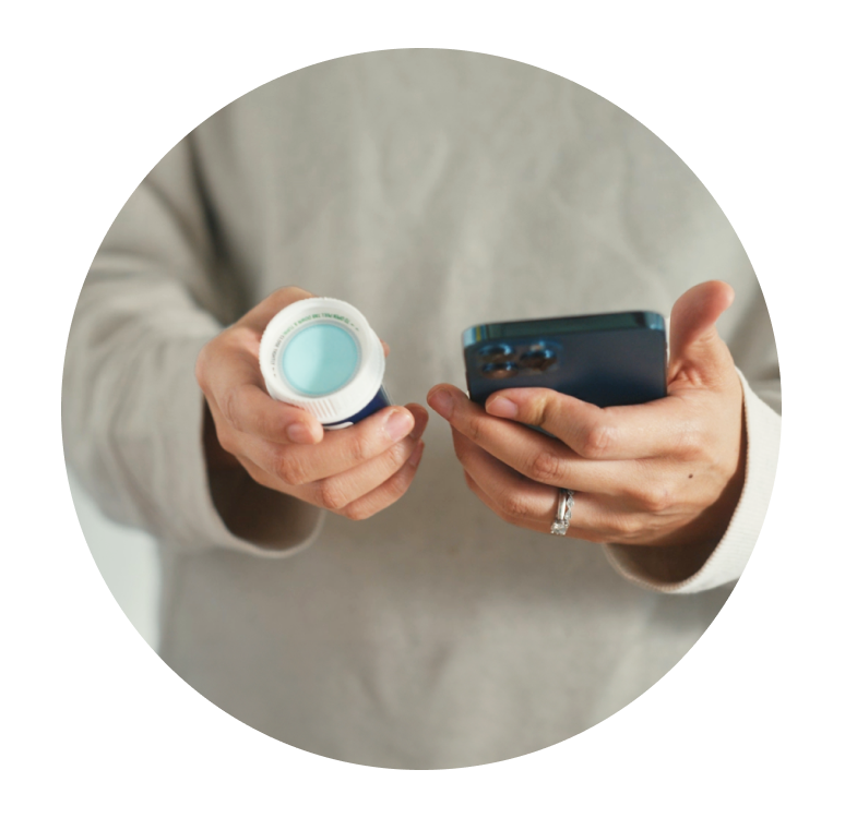 patient holding medication and phone